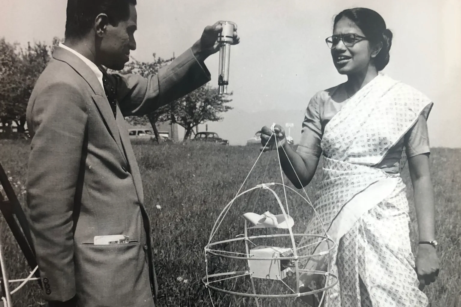 Anna Mani at a meteorological field station, standing beside weather instruments in a light sari.